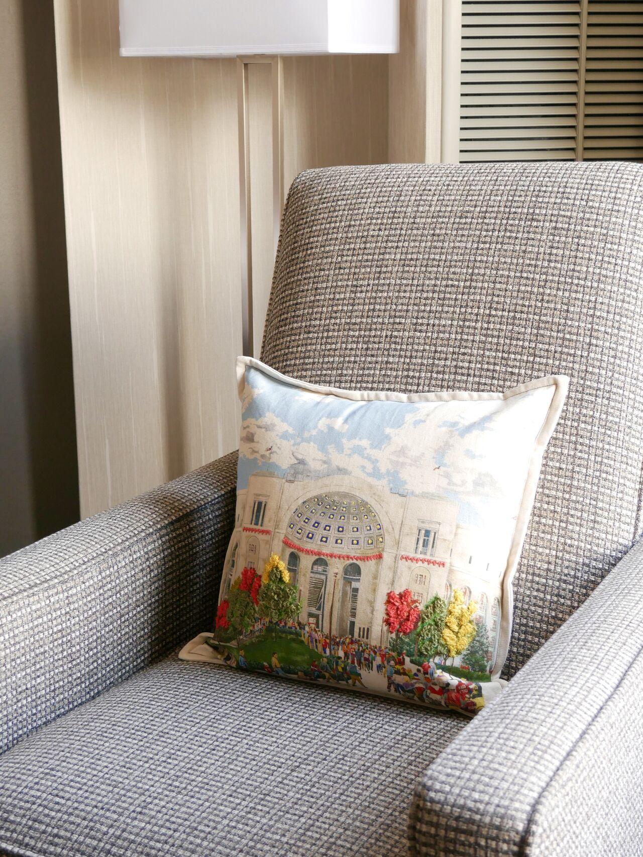 Gray chair and a throw pillow with design of Ohio Stadium Rotunda.